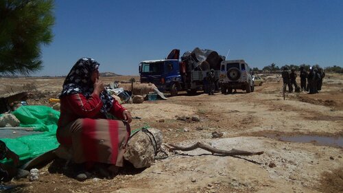 2011-07-05 Amniyr Woman watches army take tanks