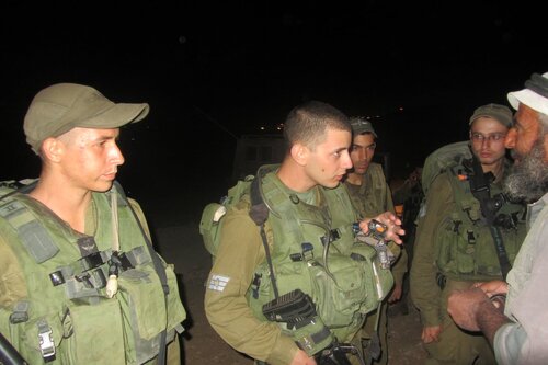 Soldati parlano con un palestinese