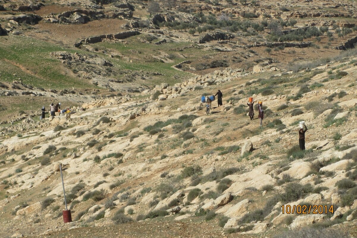 Palestinian women taking the water at the well