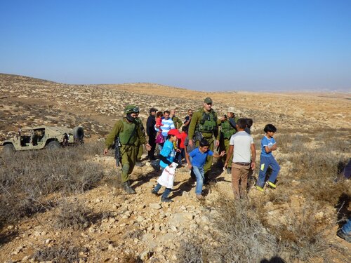 Umm Al Arayes. Soldiers push away the Palestinians after declared the area as 